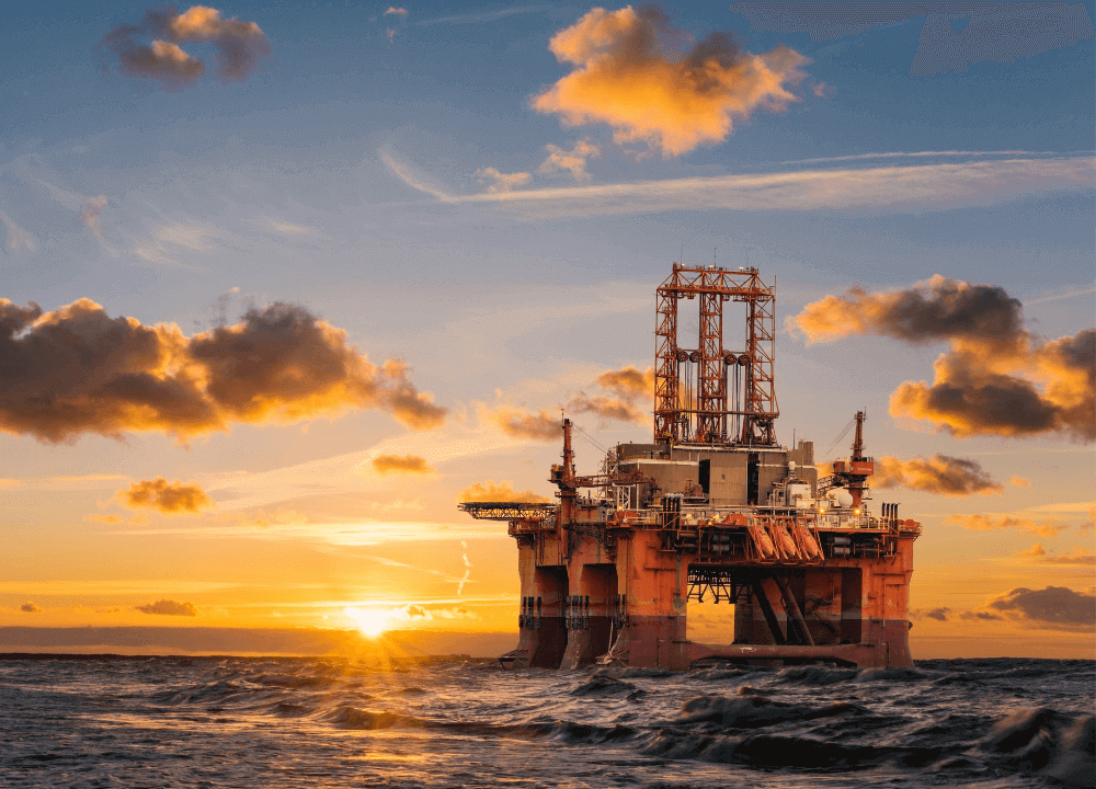 Oil rig at sea during sunset
